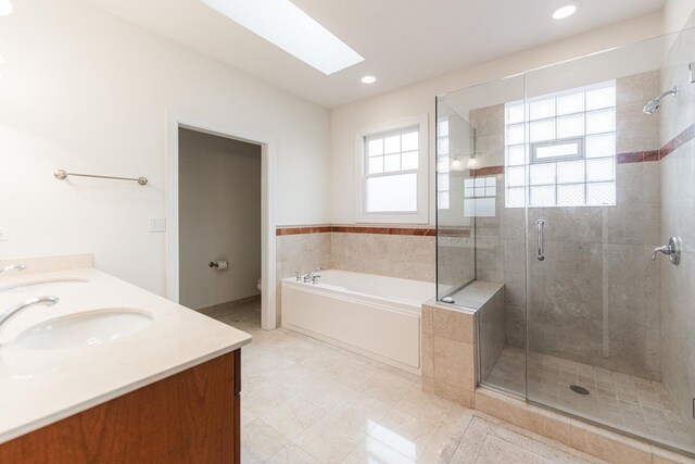 3723 N Nordica Ave, Chicago, IL 60634 - bathroom with a bath, a shower stall, double vanity, a skylight, and recessed lighting
