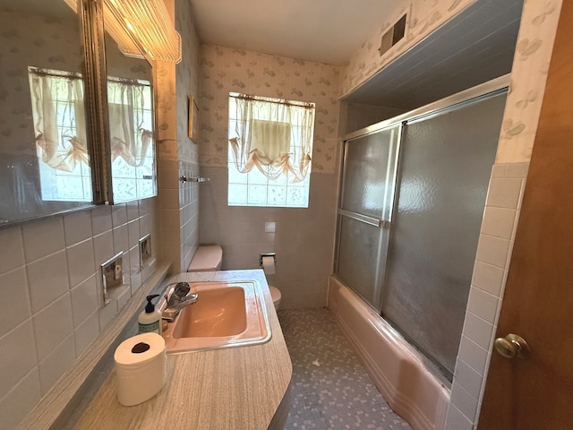 419 S Chase Ave, Lombard, IL 60148 - full bathroom with tile walls, combined bath / shower with glass door, wallpapered walls, and wainscoting