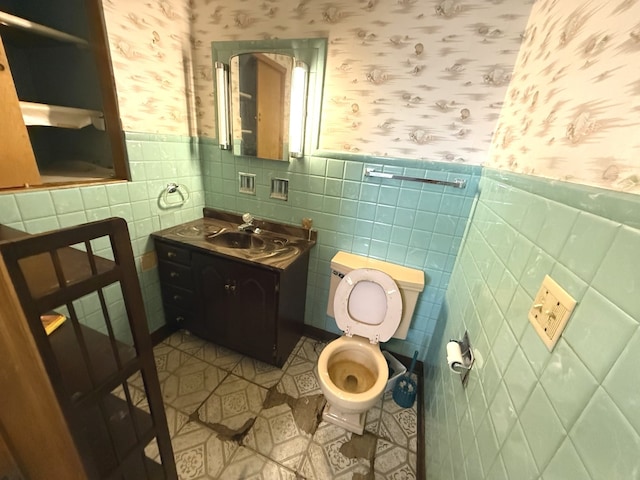 419 S Chase Ave, Lombard, IL 60148 - bathroom with wallpapered walls, wainscoting, vanity, and tile walls