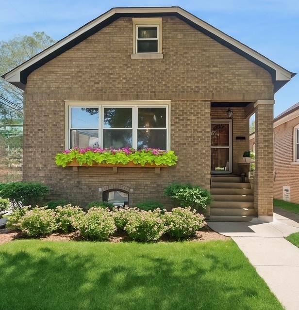 5943 N Talman Ave, Chicago, IL 60659 - view of front facade with brick siding and a front yard