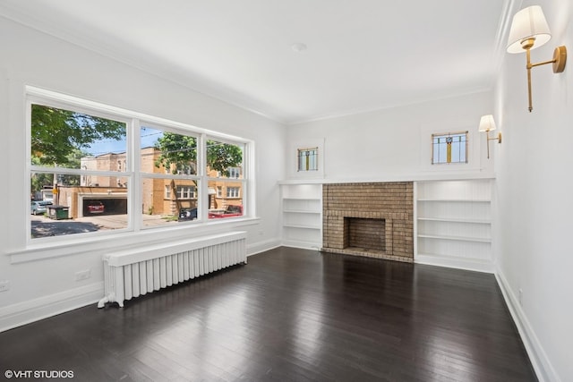 5943 N Talman Ave, Chicago, IL 60659 - unfurnished living room featuring radiator, wood finished floors, crown molding, a fireplace, and built in shelves