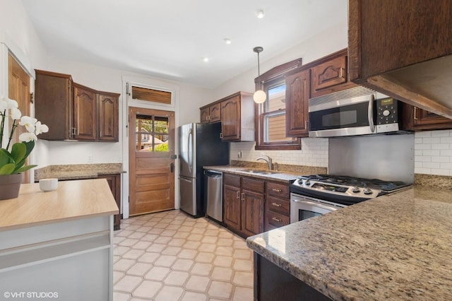 5943 N Talman Ave, Chicago, IL 60659 - kitchen with appliances with stainless steel finishes, backsplash, pendant lighting, and light stone countertops