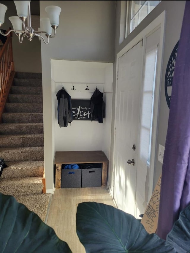 21 E Dahlia Ln, Round Lake Beach, IL 60073 - mudroom featuring a chandelier and baseboards