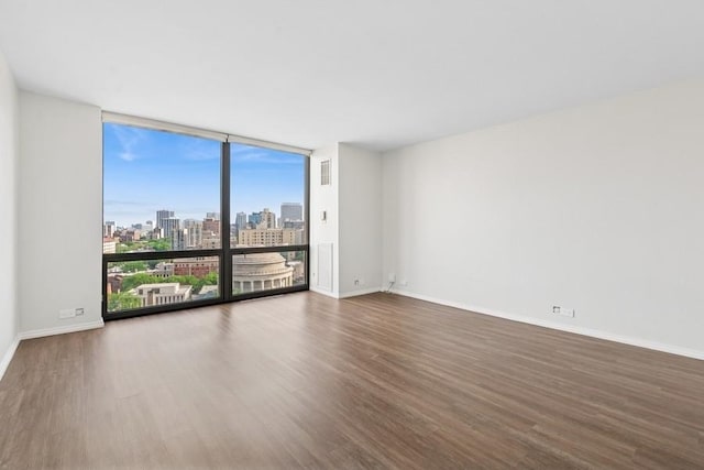 2650 N Lakeview Ave Unit 1603, Chicago, IL 60614 - spare room featuring wood finished floors, a wall of windows, and a skyline view