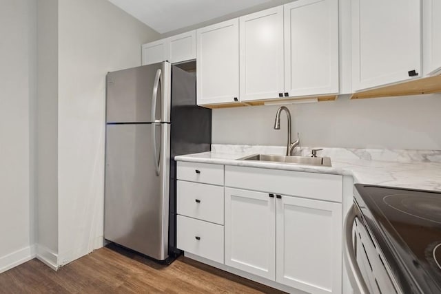 2650 N Lakeview Ave Unit 1603, Chicago, IL 60614 - kitchen featuring freestanding refrigerator, electric range, wood finished floors, white cabinetry, and light stone counters