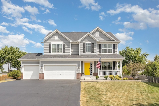 26550 W Old Stage Ln, Channahon, IL 60410 - traditional-style home with covered porch, driveway, brick siding, and an attached garage