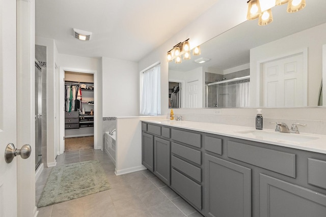 26550 W Old Stage Ln, Channahon, IL 60410 - bathroom featuring a spacious closet, a shower stall, double vanity, and tile patterned floors