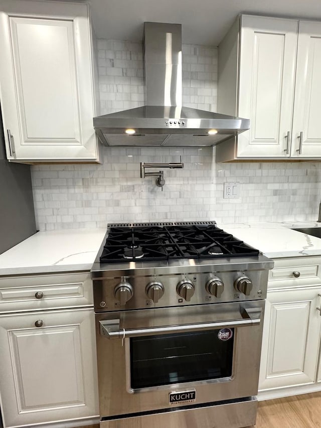 40 Portwine Rd, Willowbrook, IL 60527 - kitchen with high end stainless steel range, wall chimney exhaust hood, white cabinetry, and decorative backsplash