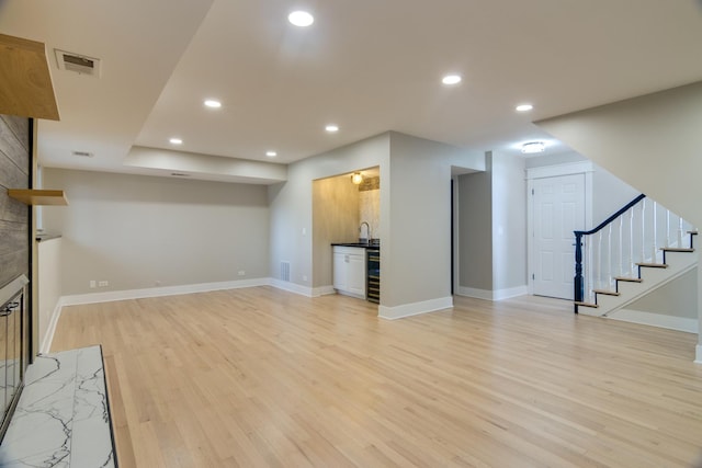 40 Portwine Rd, Willowbrook, IL 60527 - unfurnished living room featuring light wood-type flooring, bar with sink, recessed lighting, beverage cooler, and stairway