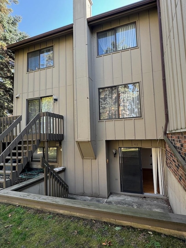 40 Portwine Rd, Willowbrook, IL 60527 - rear view of house featuring board and batten siding and a chimney