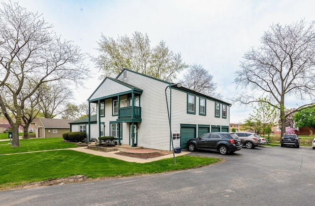 509 Darlene Ln Unit A, Glendale Heights, IL 60139 - view of front of house with a balcony, an attached garage, and a front lawn