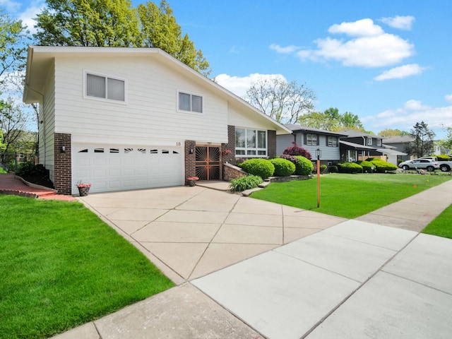 18 E 155th Pl, South Holland, IL 60473 - tri-level home with brick siding, an attached garage, a front yard, and concrete driveway
