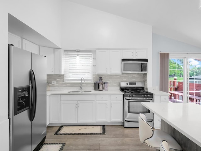 18 E 155th Pl, South Holland, IL 60473 - kitchen featuring appliances with stainless steel finishes, lofted ceiling, light countertops, and white cabinets