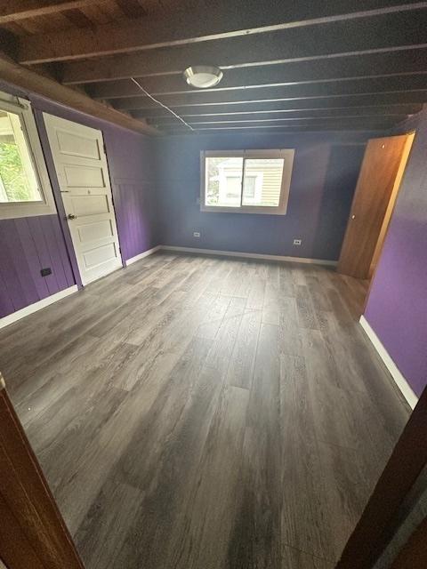 110 N Frolic Ave, Waukegan, IL 60085 - unfurnished living room featuring wood finished floors and baseboards