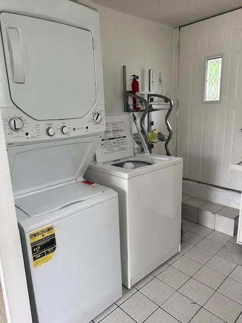110 N Frolic Ave, Waukegan, IL 60085 - laundry area featuring stacked washer and clothes dryer and light tile patterned flooring