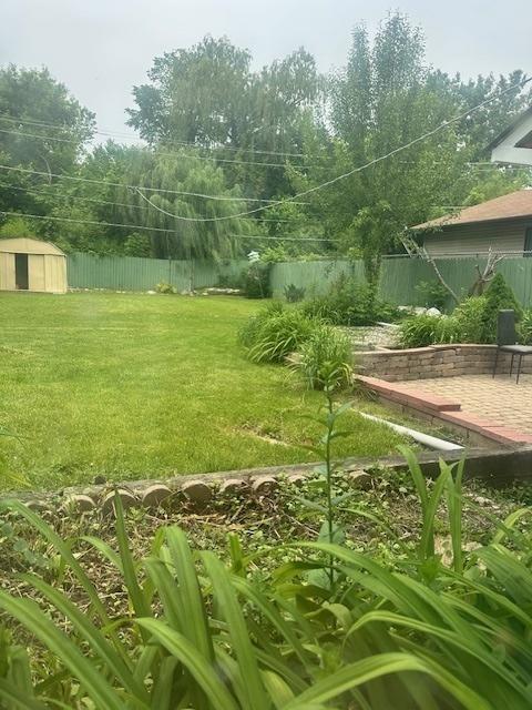 110 N Frolic Ave, Waukegan, IL 60085 - fenced backyard with a storage unit