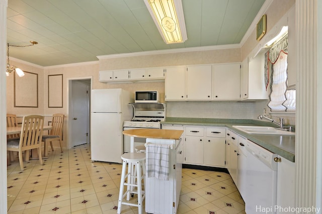 36 S Pistakee Lake Rd, Fox Lake, IL 60020 - kitchen with white appliances, a kitchen island, white cabinets, crown molding, and a breakfast bar area