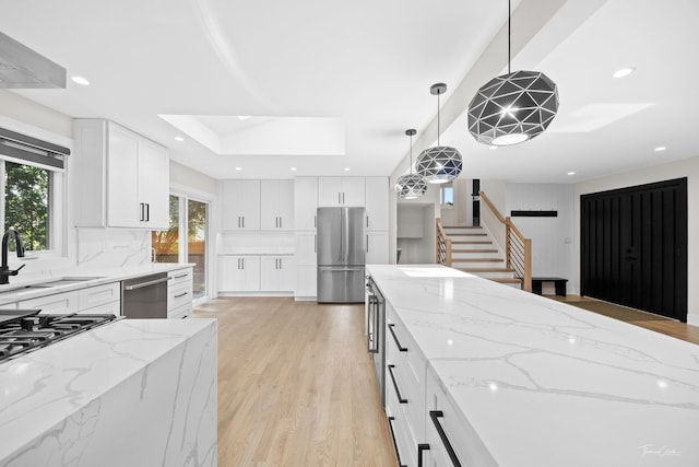 13741 S 85th Ave, Orland Park, IL 60462 - kitchen with appliances with stainless steel finishes, light wood-style flooring, light stone counters, backsplash, and decorative light fixtures