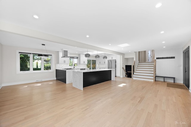 13741 S 85th Ave, Orland Park, IL 60462 - kitchen featuring light countertops, a kitchen island, white cabinets, stainless steel fridge, and light wood-style floors