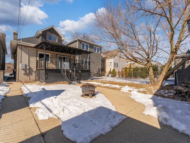 2529 Scoville Ave, Berwyn, IL 60402 - snow covered rear of property with a fire pit and a chimney