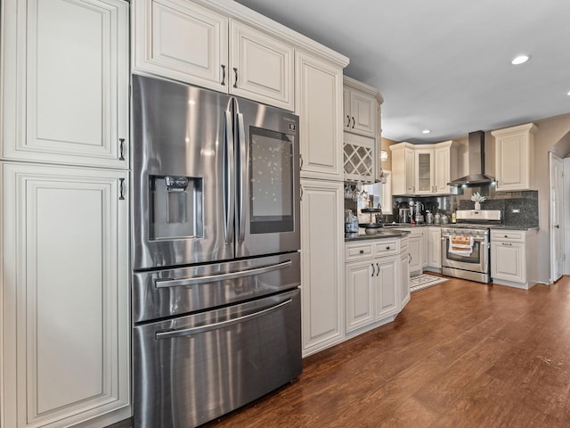 2529 Scoville Ave, Berwyn, IL 60402 - kitchen featuring appliances with stainless steel finishes, wall chimney exhaust hood, dark wood-style flooring, tasteful backsplash, and recessed lighting