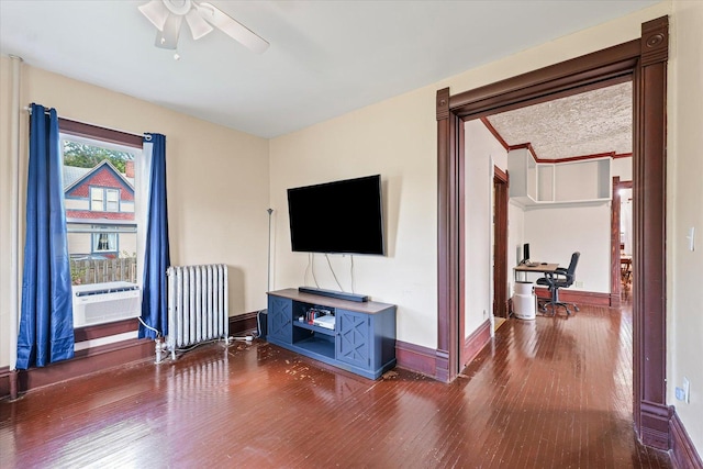 543 E Orleans St, Paxton, IL 60957 - living area featuring radiator, wood finished floors, ceiling fan, and cooling unit