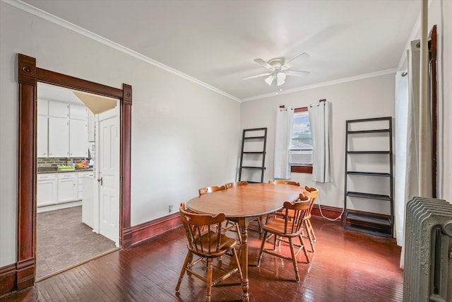 543 E Orleans St, Paxton, IL 60957 - dining area featuring ceiling fan, dark wood-type flooring, radiator, and crown molding