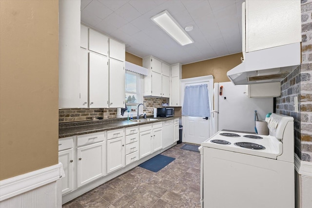 543 E Orleans St, Paxton, IL 60957 - kitchen with white appliances, ventilation hood, white cabinetry, dark countertops, and decorative backsplash