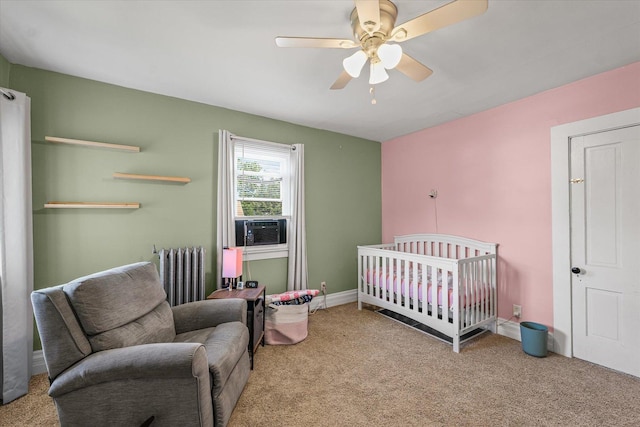 543 E Orleans St, Paxton, IL 60957 - bedroom featuring radiator, carpet, a ceiling fan, cooling unit, and a nursery area