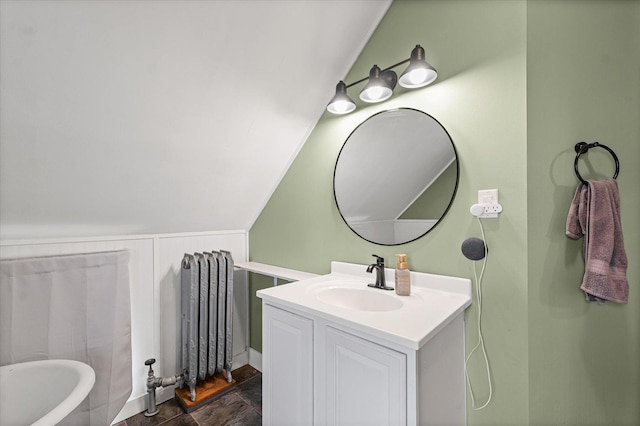 543 E Orleans St, Paxton, IL 60957 - full bath with radiator heating unit, vaulted ceiling, vanity, and stone finish floors