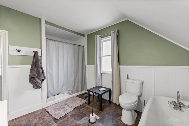 543 E Orleans St, Paxton, IL 60957 - full bathroom featuring wainscoting, lofted ceiling, curtained shower, a bath, and stone finish floors