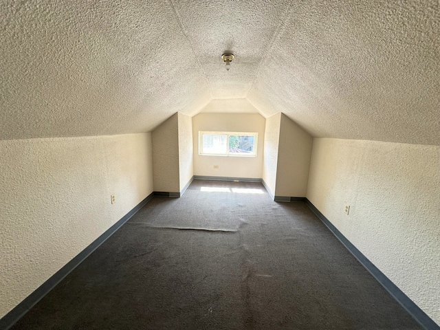 5608 S Spaulding Ave, Chicago, IL 60629 - additional living space with a textured wall, vaulted ceiling, a textured ceiling, and carpet