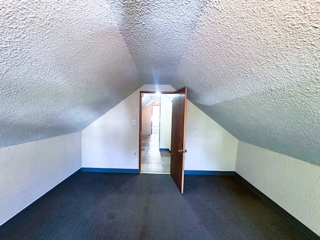 5608 S Spaulding Ave, Chicago, IL 60629 - bonus room featuring a textured ceiling, a textured wall, vaulted ceiling, and carpet