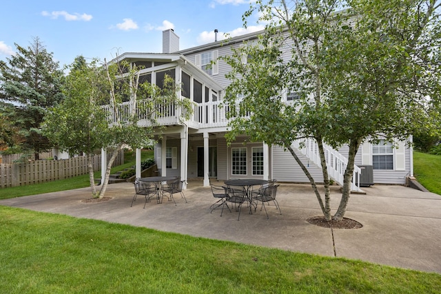 514 Abbeywood Dr, Cary, IL 60013 - back of property with a sunroom, a patio area, a chimney, and a wooden deck