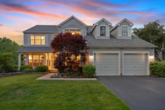 514 Abbeywood Dr, Cary, IL 60013 - view of front facade with asphalt driveway, a front lawn, a shingled roof, and a garage