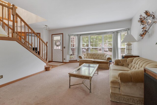 514 Abbeywood Dr, Cary, IL 60013 - carpeted living room with stairs and baseboards