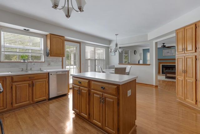 514 Abbeywood Dr, Cary, IL 60013 - kitchen with a chandelier, dishwasher, light wood-style floors, a center island, and light countertops