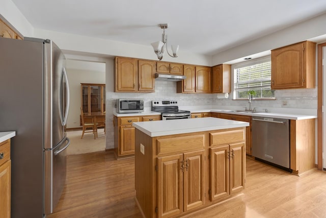 514 Abbeywood Dr, Cary, IL 60013 - kitchen with stainless steel appliances, under cabinet range hood, light wood finished floors, and light countertops