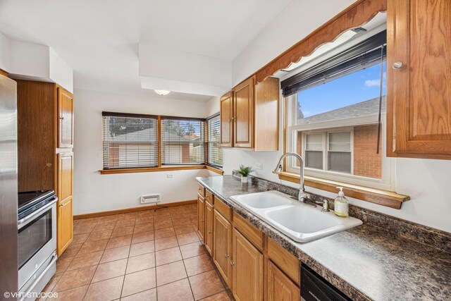 1627 Downing Ave, Westchester, IL 60154 - kitchen with stainless steel electric range oven, healthy amount of natural light, dark countertops, and light tile patterned floors