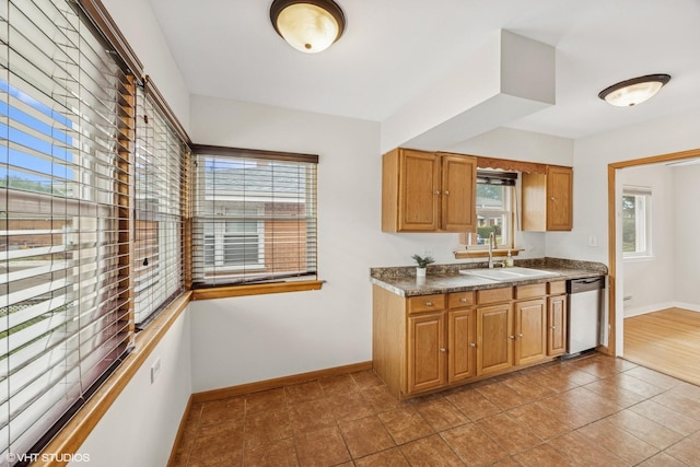 1627 Downing Ave, Westchester, IL 60154 - kitchen with dishwasher, healthy amount of natural light, brown cabinets, and dark countertops