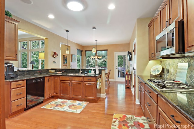 9516 Thousand Oaks Dr, Spring Grove, IL 60081 - kitchen with appliances with stainless steel finishes, a peninsula, light wood finished floors, brown cabinetry, and recessed lighting