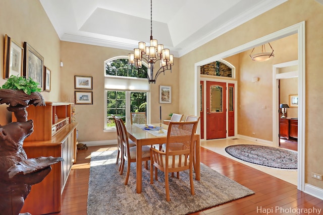 9516 Thousand Oaks Dr, Spring Grove, IL 60081 - dining room with wood-type flooring, ornamental molding, a chandelier, a high ceiling, and a raised ceiling