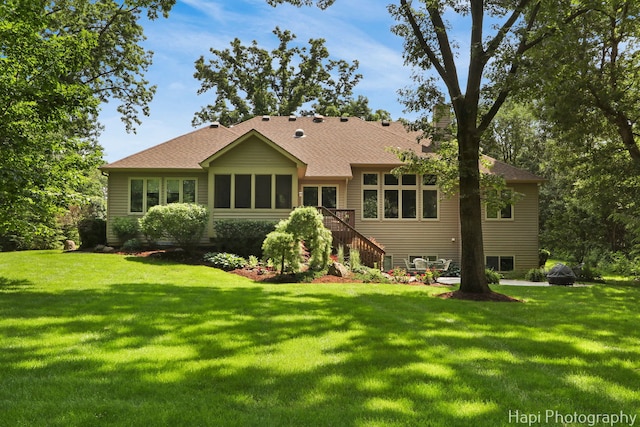 9516 Thousand Oaks Dr, Spring Grove, IL 60081 - rear view of property featuring stairs, a yard, a sunroom, and roof with shingles
