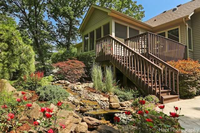 9516 Thousand Oaks Dr, Spring Grove, IL 60081 - view of home's exterior with a sunroom and a shingled roof