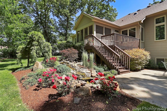 9516 Thousand Oaks Dr, Spring Grove, IL 60081 - view of side of home featuring a sunroom, stairway, a patio area, and roof with shingles