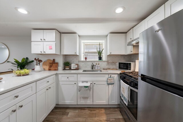 1630 N Avers Ave, Chicago, IL 60647 - kitchen featuring appliances with stainless steel finishes, decorative backsplash, light countertops, white cabinets, and recessed lighting