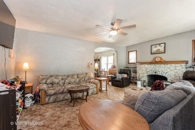 1429 N May St, Joliet, IL 60435 - carpeted living room with ceiling fan, arched walkways, and a stone fireplace