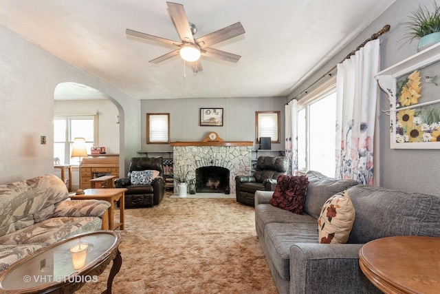 1429 N May St, Joliet, IL 60435 - carpeted living room with healthy amount of natural light, a ceiling fan, arched walkways, and a stone fireplace