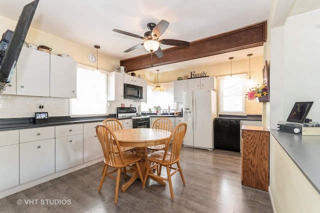 1429 N May St, Joliet, IL 60435 - kitchen featuring black appliances, dark countertops, dark wood-style floors, decorative backsplash, and beamed ceiling