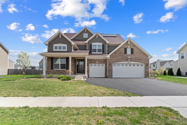 153 N Bend Way, Elgin, IL 60124 - view of front facade featuring driveway, brick siding, solar panels, and a garage